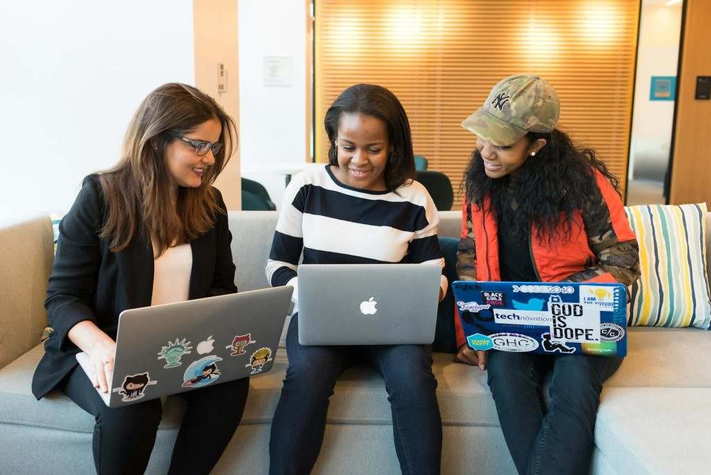 three woman in front of laptop computer